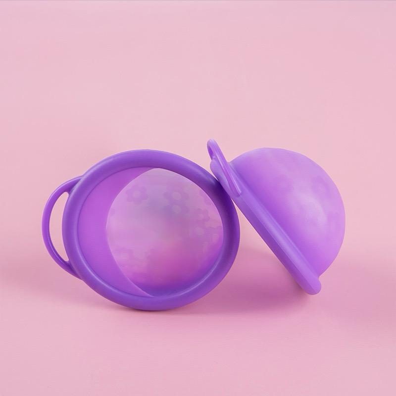 Dreamy purple reusable menstrual disc shown from above and from the side